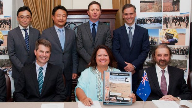 Ambition realised ... Gina Rinehart shows the debt funding agreement at the signing event in Singapore.