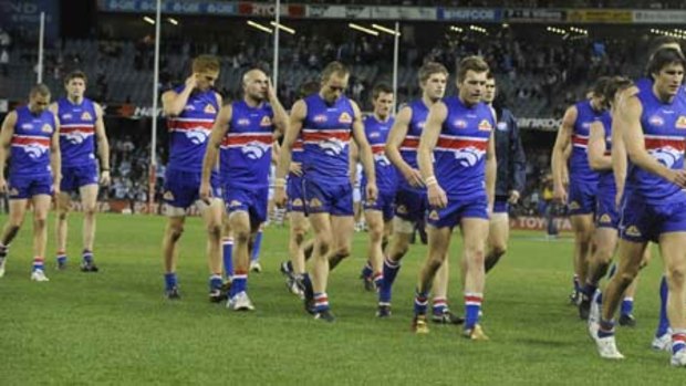 The Western Bulldogs are bowed and beaten as they trudge off Etihad Stadium after their 101-point humiliation by Geelong in round 20.