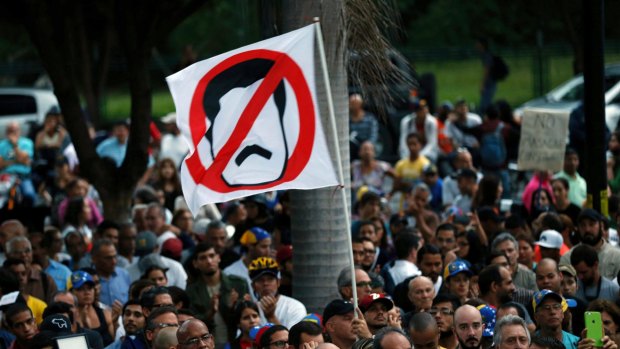 Anti-government demonstrators protest against Venezuelan President Nicolas Maduro in Caracas on Monday, during a vigil for those killed during clashes with government troops.