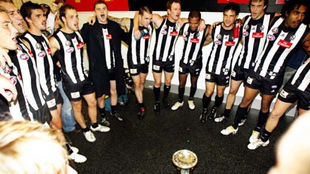 The victorious Collingwood team belts out the club song in the rooms after destroying an insipid Essendon in the Anzac Day match at the MCG yesterday.