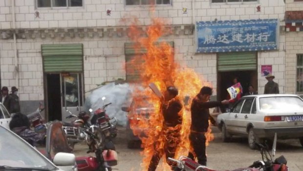 Fatal decision: Tenzin Khedup and Ngawang Norphel, holding Tibetan flags, set themselves alight in Yushu prefecture in China's Qinghai province.