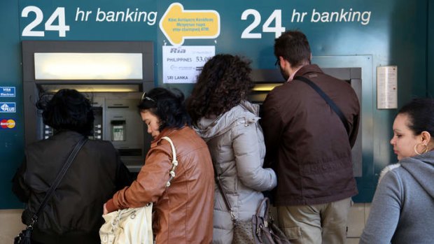 Cyprus customers at an ATM.