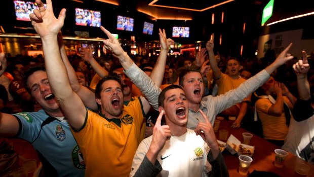 Football fans watch the Australia v Holland World Cup match at the Star's Sports Bar.