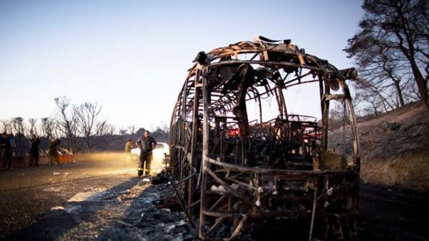 Disaster ... a burnt-out bus in which 37 were killed.