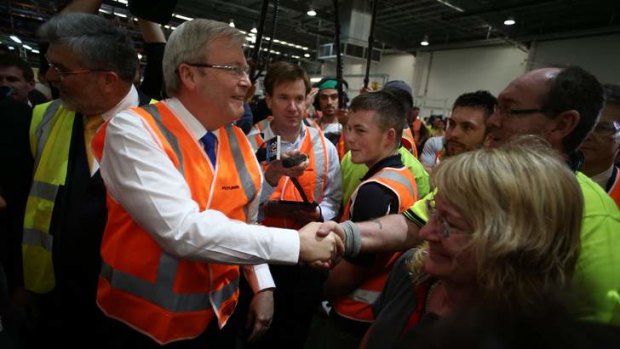 Busy bee: Kevin Rudd meets workers at a Melbourne cabling company.