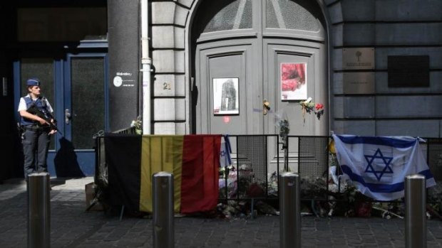 A police officer stands guard in front of the Jewish Museum in Brussels after the fatal shootings on May 24.