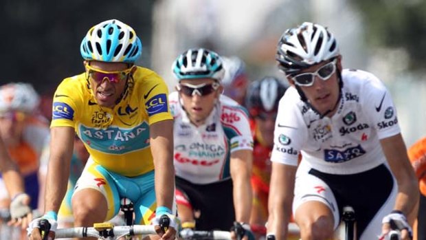 Alberto Contador (l) rides over the finish line alongside second placed Andy Schleck of Luxembourg on stage sixteen.