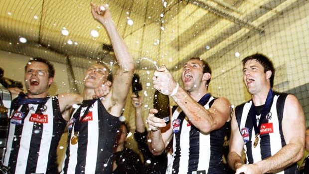 Travis Cloke, second from right, celebrates the 2010 Collingwood premiership with Nathan Brown, Ben Reid, and Leigh Brown.
