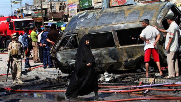 Wave of attacks: A van destroyed by a car bomb in Basra on Monday.