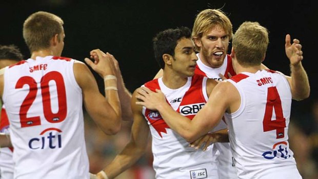 Sydney's Lewis Roberts-Thomson (second from right), who kicked three goals, celebrates with teammates Sam Reid (left) and Daniel Hannebery during the win over the Brisbane Lions.