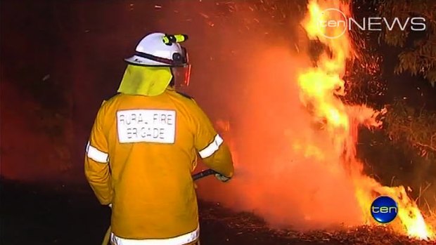 Firefighters battle a blaze in the Gold Coast hinterland where a body was later found.