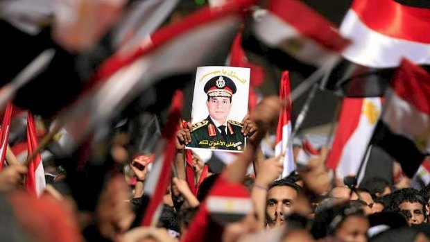 Protesters hold a poster featuring the head of Egypt's armed forces, General Abdel Fattah al-Sisi, in Cairo on July 3.