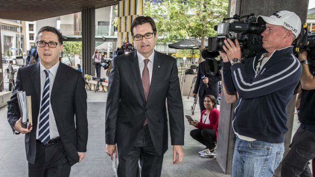 Former Rudd government minister Greg Combet (centre) arrives at the royal commission in Brisbane.