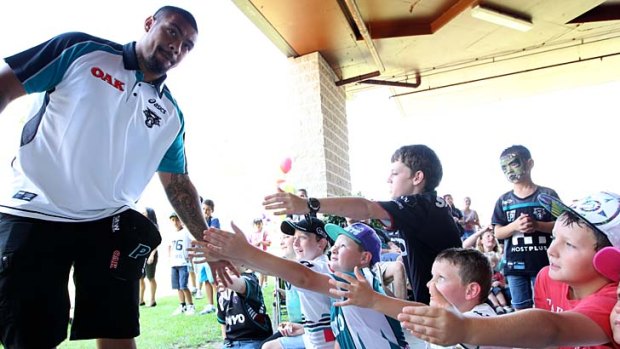 Reaching out to the community &#8230; star recruit Sika Manu meets some young Panthers supporters at the club's fan day in Penrith on Saturday.