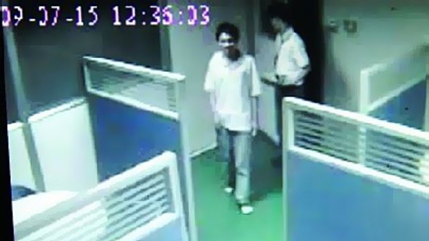 A video screen grab obtained by the Southern Metropolis Daily purporting to show Foxconn employee  Sun Danyong being let into a room to be questioned on July 15.   Photo is a video screen grab showing Sun Danyong being ushered into a room to be interviewed.