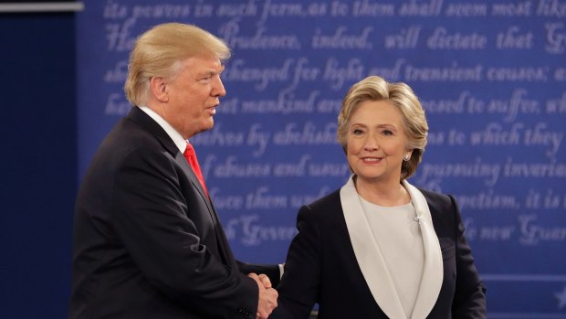 Republican presidential nominee Donald Trump shakes hands with Democratic presidential nominee Hillary Clinton during the second presidential debate.