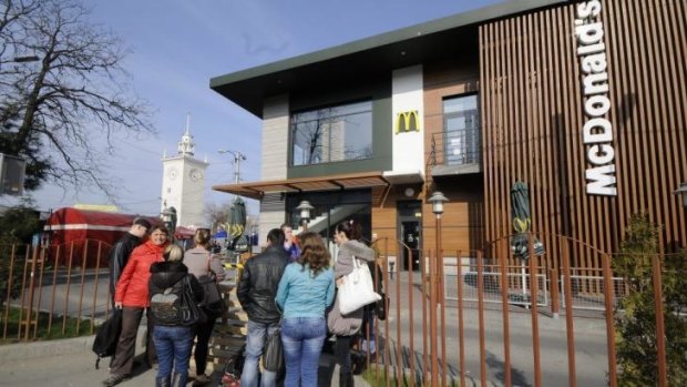 Hold the fries ... People stand outside a closed McDonald's restaurant in the city of Simferopol in Crimea on Friday.