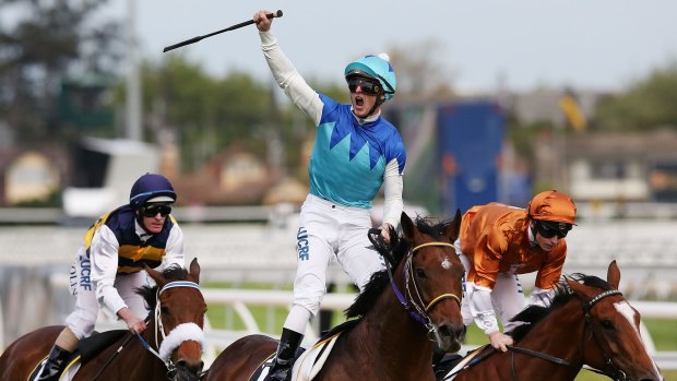 Zac Purton celebrates after taking out the Caulfield Cup aboard Admire Rakti.