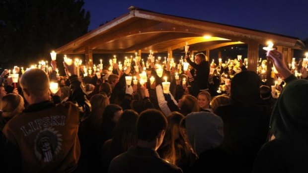 United: Hundreds of Arapahoe High School students gathered for a candlelight vigil Saturday night,  to share their prayers for Claire Davis who was shot inside the school on Friday.