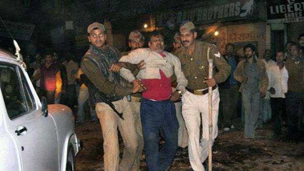Indian police help an injured victim after the explosion in Varanasi.