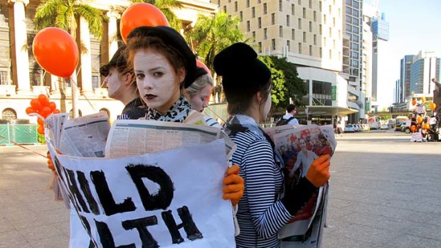 Young people dressed as mimes descend on King George Square to raise awareness of third world children dying of preventable diseases.