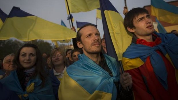 Ukrainians with their national flags gather in support of a united Ukraine in Donetsk.