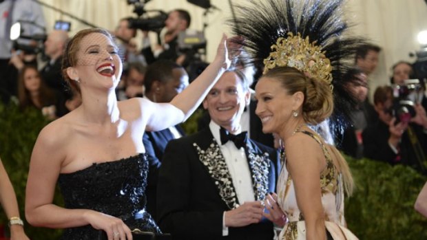 Jennifer Lawrence having a joke at the expensive of Sarah Jessica Parker's Philip Treacy headpiece at the Punk: Chaos to Couture 2013 Met Ball this week.
