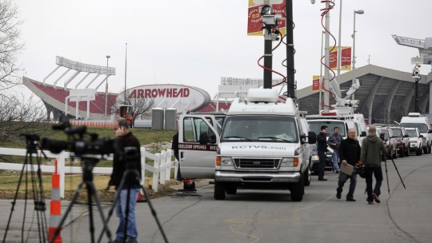 Members of the media gather near Arrowhead Stadium in Kansas City as they report on the death of Jovan Belcher, who allegedly shot and killed his girlfriend before killing himself.