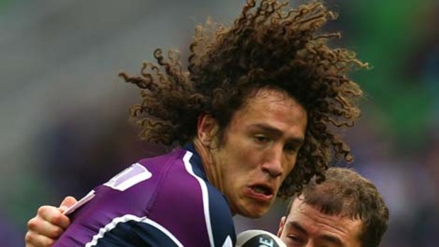 Kevin Proctor of the Storm is tackled by Terry Campese of the Raiders.