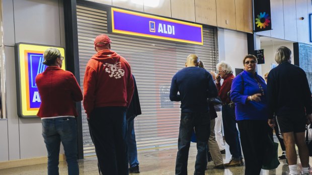 Shoppers wait for the opening of the new Casey Aldi store on Wednesday. There will soon be almost double the number of Aldi stores northside compared to southside.