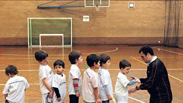 Join the queue ... boys and girls in the Soccajoeys program at Five Dock Leisure Centre. The students, aged from three to five, learn basic football skills which help develop co-ordination and motor skills.