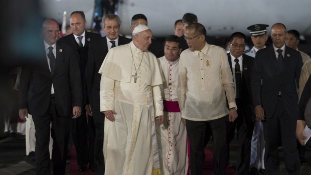 Pope Francis is greeted by Philippines' President Benigno Aquino (centre right) upon his arrival at Villamor Air Base for a state and pastoral visit, in Manila.