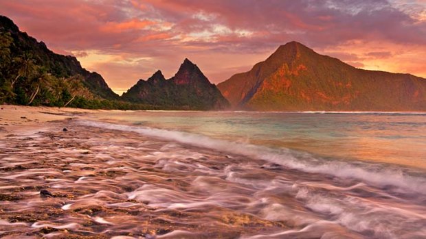 Pacific passion ... a dramatic sunset from the pristine coral sand beach on Ofu Island, American Samoa.