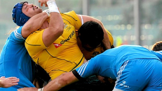 Wallabies skipper Nathan Sharpe is tackled by Martin Castrogiovanni.