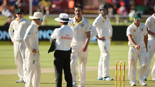 Michael Clarke and Mitchell Johnson remonstrate with umpire Aleem Dar after a review decision for the wicket of Vernon Philander.