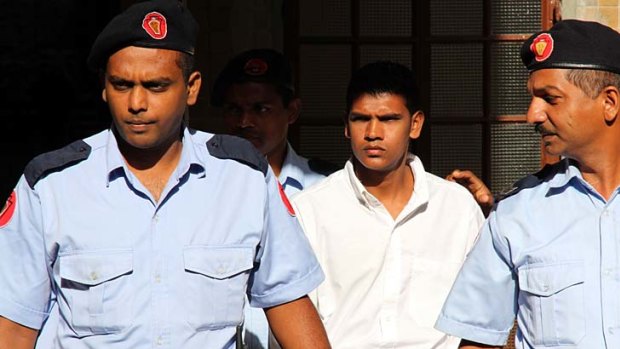 Accused ... Avinash Treebhoowoon, centre, leaves the court.