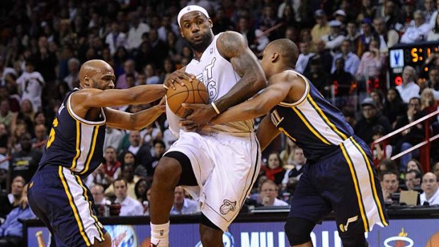 Jamaal Tinsley (left) and Randy Foye (right) of the Utah Jazz try to block the Heat's LeBron James.