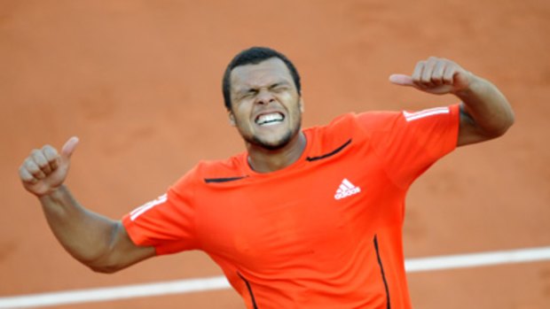 France's Jo-Wilfried Tsonga reacts as he defeats Germany's Daniel Brands in the first round of the French Open.