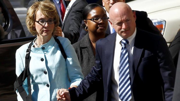 'Changed forever' ... Gabrielle Giffords her husband, Mark Kelly, leave court after the sentencing of Jared Loughner.