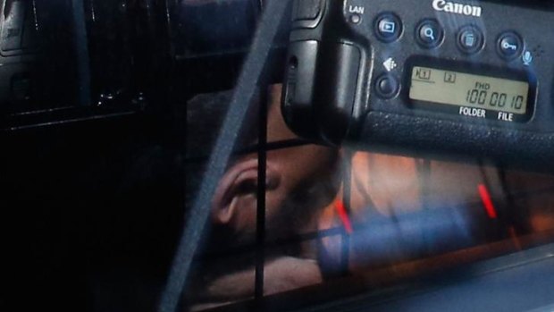 Omarjan Azari under police guard at Sydney's Central Local Court.