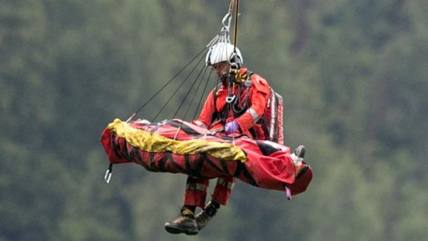 A person injured in the train crash near Tiefencastel, Switzerland, is airlifted by helicopter from the scene.