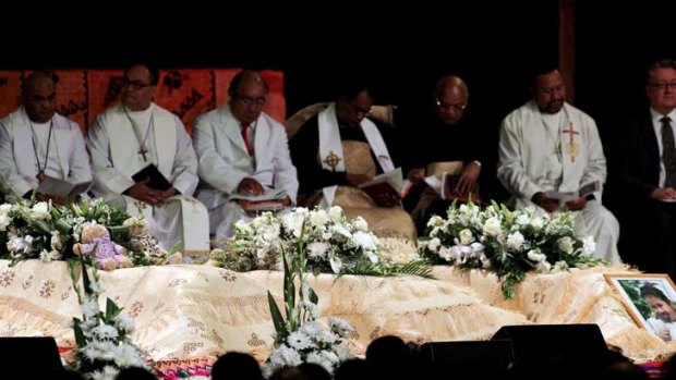 Solemn ... the funeral held inside Citipointe Church in Carindale yesterday for the members of the Taufa family, who died in the house fire at Slacks Creek.