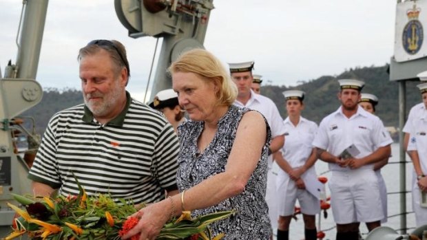 Robyn Rosenstrauss, whose great-uncle James Fette perished on the AE1, prepares with her husband, Graham, to throw flowers off the stern of HMAS Yarra on Wednesday.