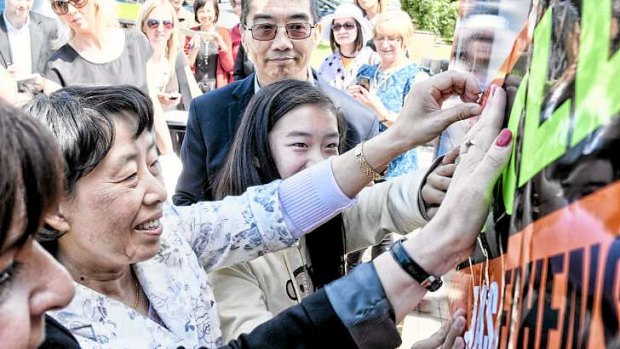 Jian Wang with daughter Charlotte and husband Zheung after buying Julia Gillard's house in Altona.