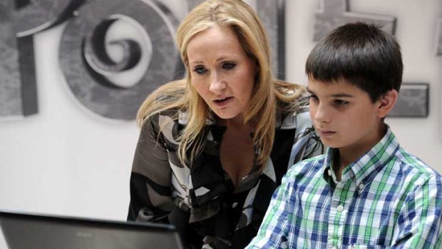 Harry Potter creator JK Rowling poses with a young boy during the launch of her new project.