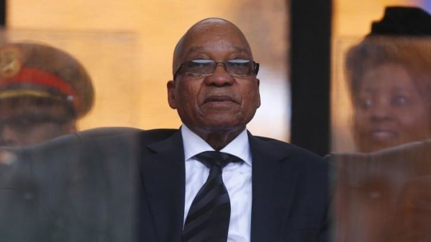 South African President Jacob Zuma holds the official program for the memorial service for late South African President Nelson Mandela at the FNB soccer stadium in Johannesburg.