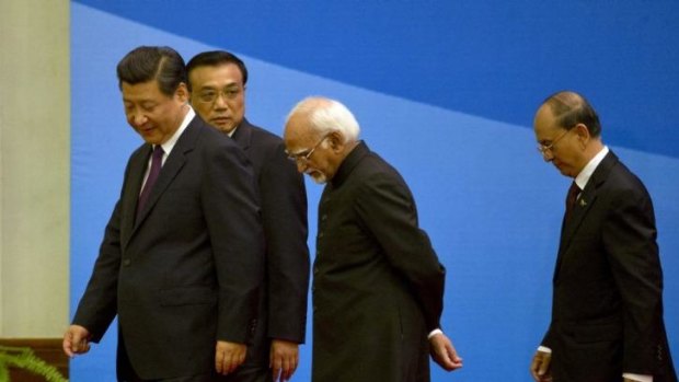 Chinese President Xi Jinping, left, walks with Chinese Premier Li Keqiang, Indian Vice-President Hamid Ansari, centre, and Myanmar President Thein Sein in Beijing.