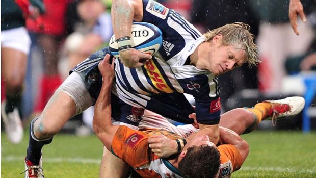 Slippery when wet ... Joe Pietersen of the Stormers is tackled.