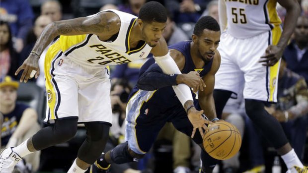 Indiana Pacers forward Paul George, left, and Memphis Grizzlies guard Mike Conley go for a loose ball in the second half in Indianapolis. The Pacers defeated the Grizzlies 95-79.