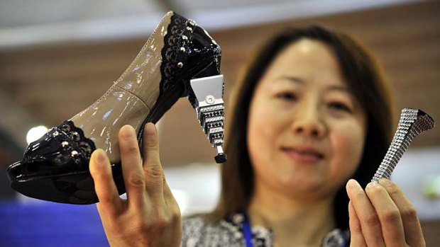 Taiwan's Juang Ying-Shen poses with her invention, high heels with interchangeable components.